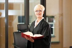Female lawyer with German civil law code - only torso to be seen